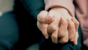 Two people holding hands