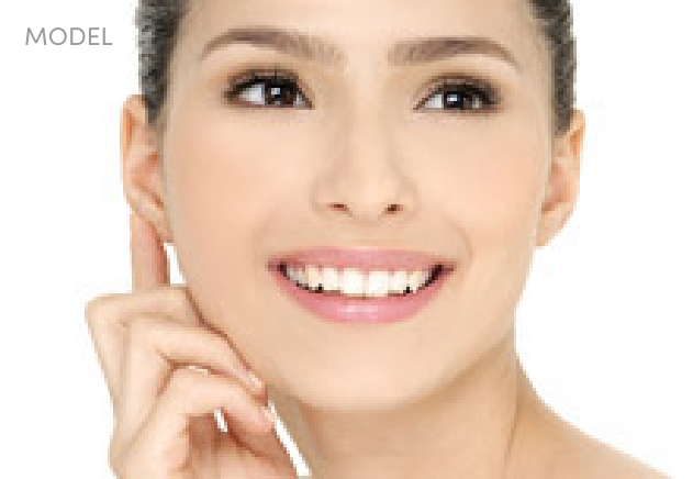Headshot of Brunette Woman with Her Hand to her Cheek and Ear