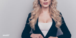 Female with lifted breasts in a blazer and tank
