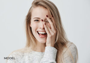 Laughing Female Covering Half Her Face with Hand